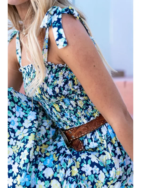 A woman wearing a blue floral dress.