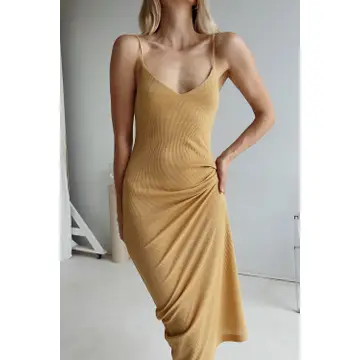 Woman wearing yellow ribbed jersey dress.