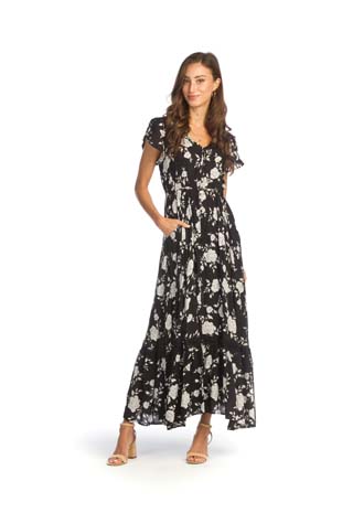 Woman wearing a black and white floral maxi dress.