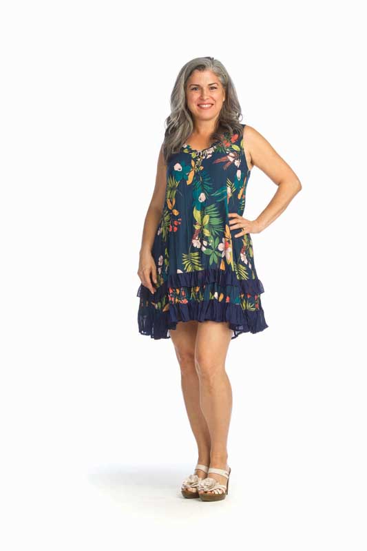 Woman wearing sleeveless blue floral dress.