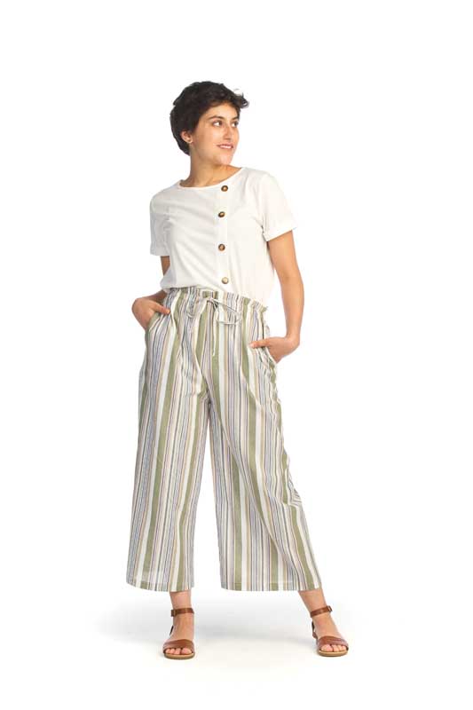 A woman wearing a white shirt and striped pants.