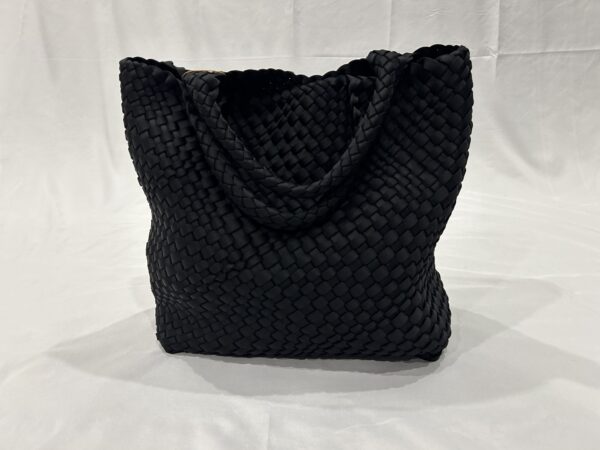 Black woven tote bag with brown handles.