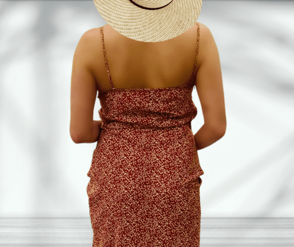 Woman in floral dress and straw hat.