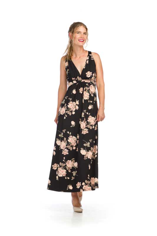 Woman in floral maxi dress smiling.